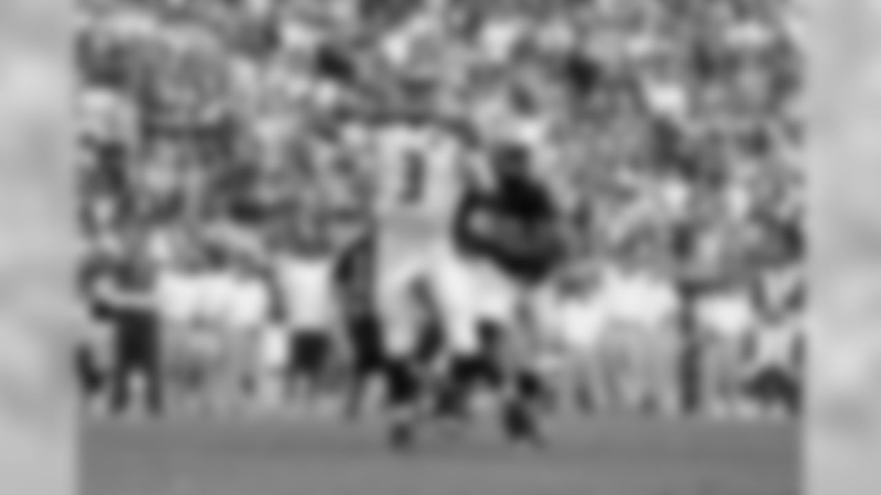 Jameis Winston fleeing a Titans defender.