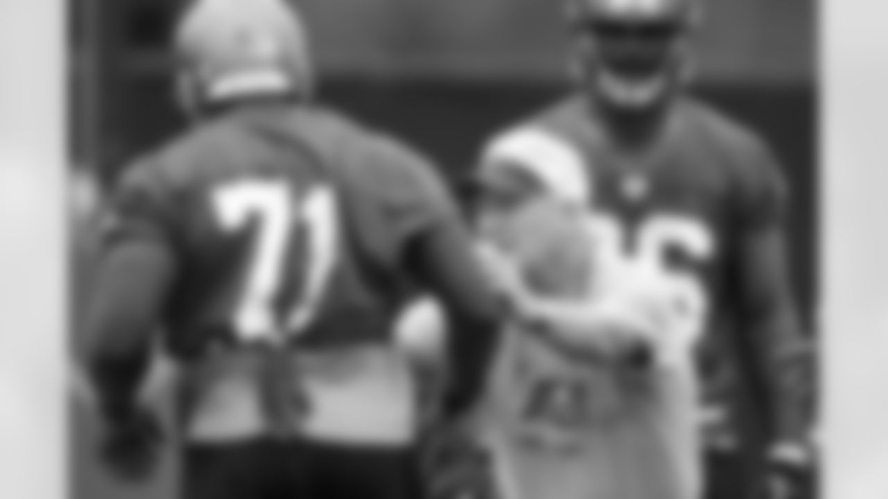 Defensive Line Coach Larry Coyer gives a hands-on lesson to DT Jovan Haye