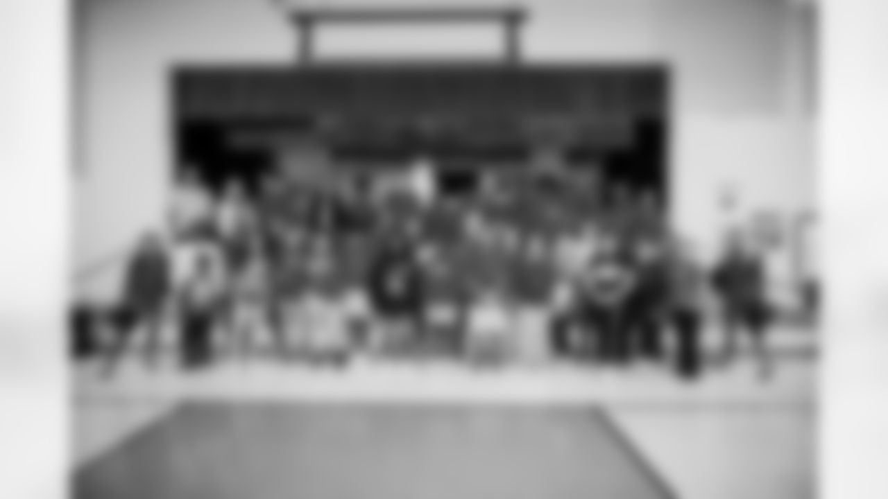 TAMPA, FL - December 15, 2022 - Students and staff share food, gifts, and games, during the 2022 Youth Leadership Program holiday party at Young Middle Magnet School. Photo By Kyle Zedaker/Tampa Bay Buccaneers