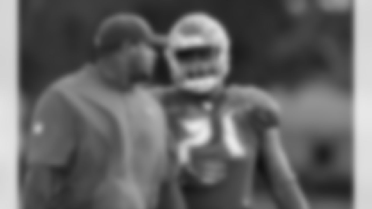 Assistant Defensive Line Coach Paul Spicer and #71 DE Channing Ward