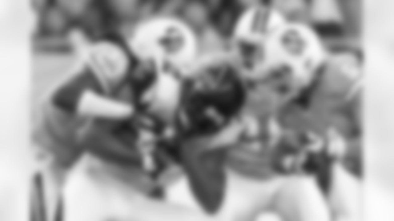 23 CB Myron Lewis wrestles the receiver for the ball on the tackle