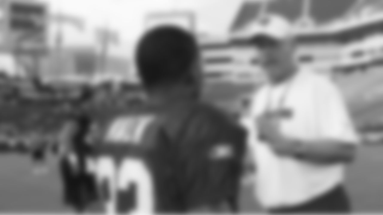 Defensive Coordinator Jim Bates takes time to give direction to CB Elbert Mack