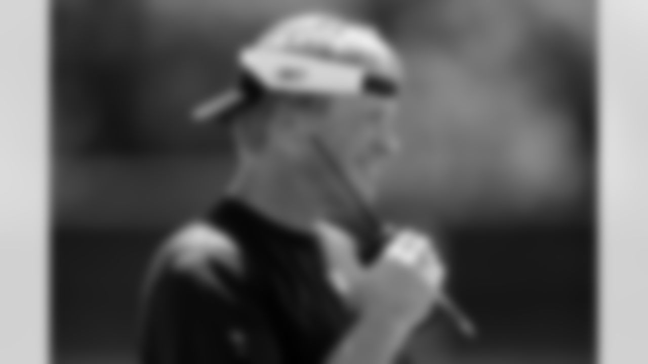 Head Coach Jon Gruden sends in a play over the QB helmet radio