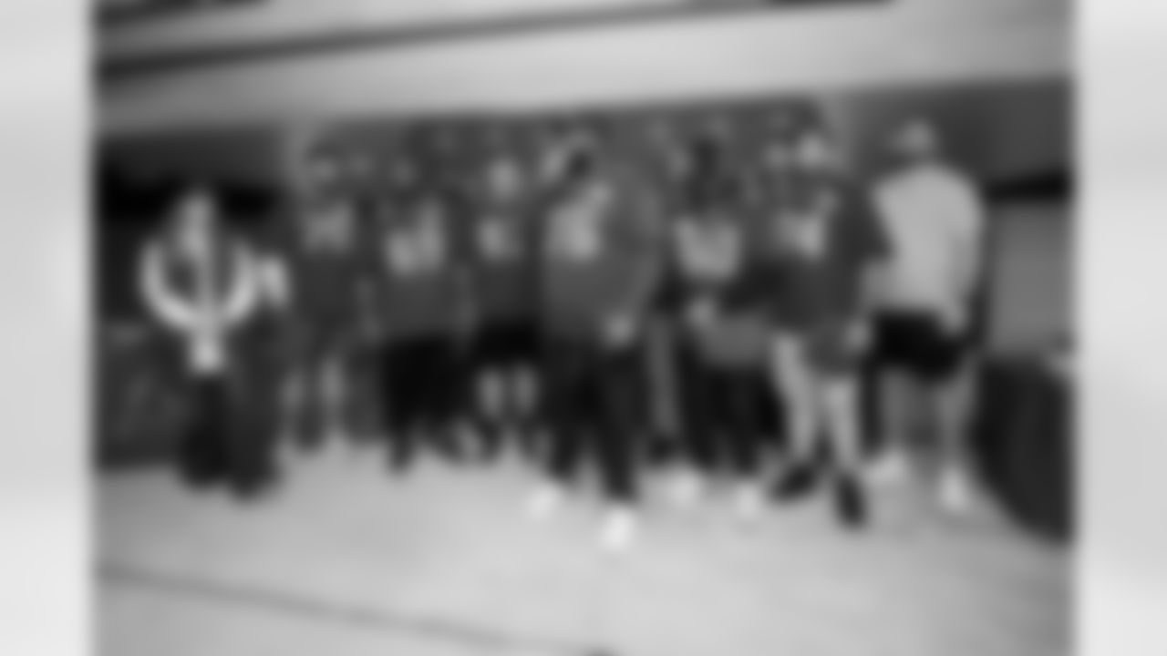 TAMPA, FL - December 19, 2022 - Vice President of Community Impact and Executive Director of Glazer Vision Foundation Tara Battiato, Offensive Lineman Robert Hainsey #70, Guard Shaq Mason #69, Tackle Brandon Walton #73, Guard Luke Goedeke #67, Running Back Rachaad White #29, Offensive Tackle Donovan Smith #76, Guard Nick Leverett #60, Center Ryan Jensen #66, Tackle Justin Skule #77, Guard Aaron Stinnie #64 and Tackle Grant Hermanns #74 of the Tampa Bay Buccaneers during O-Line Lights Up Christmas at Target. Photo By Tori Richman/Tampa Bay Buccaneers