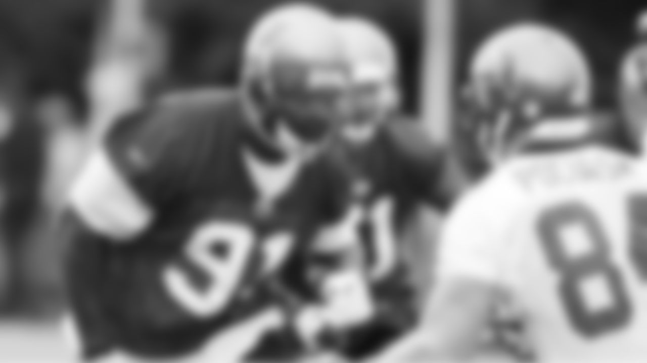 DE Stylez G. White puts a pass-rush move on TE Jason Pociask