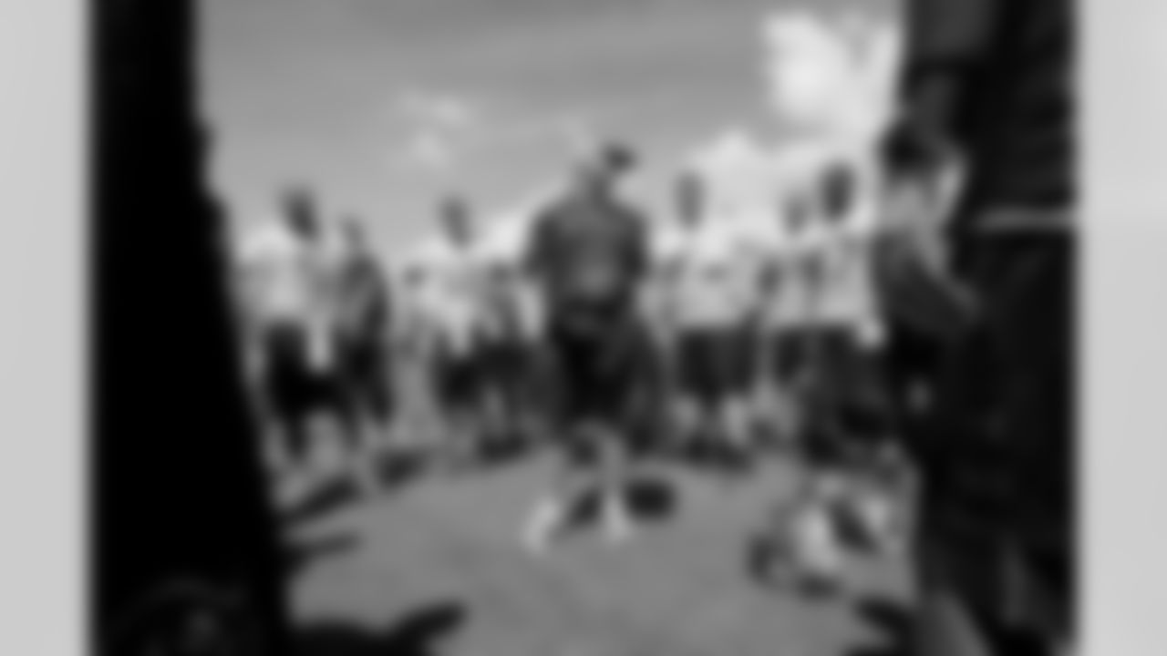 Head Coach Jon Gruden addresses the team at the end-of-practice huddle