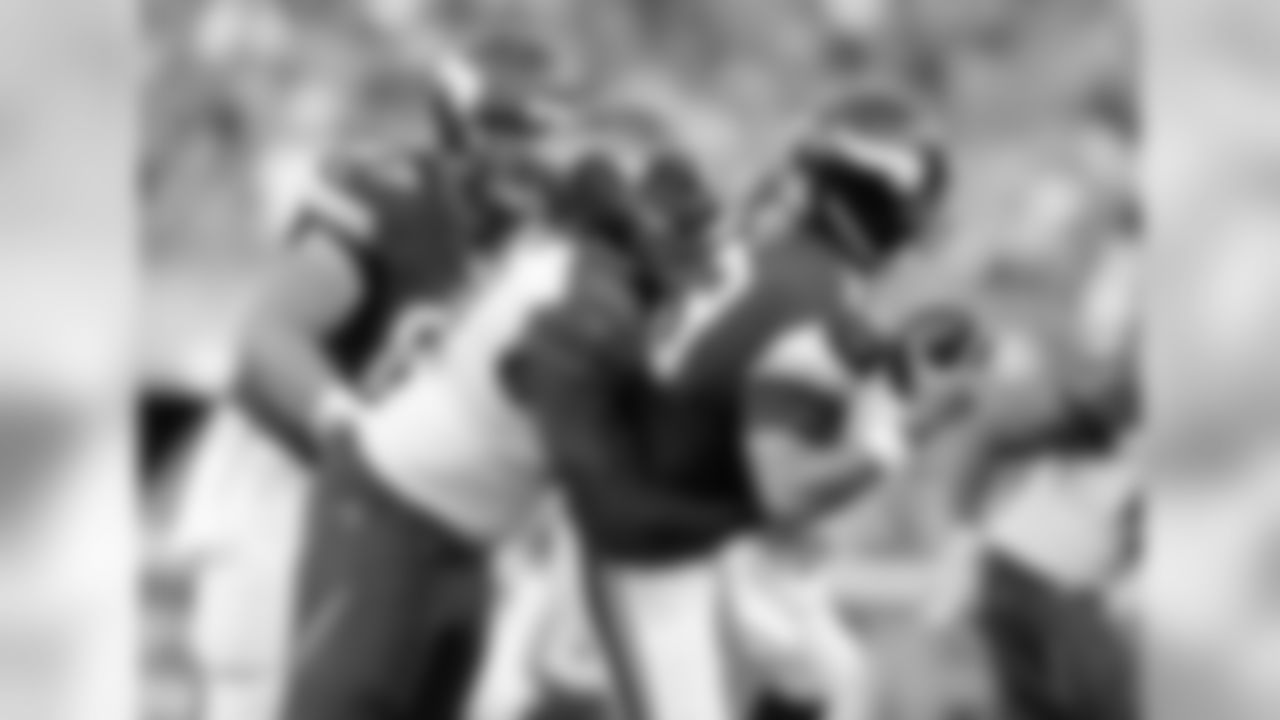 First-year Buccaneer DT Henry Melton (90) sacks Vikings' QB Shaun Hill to start the second quarter.