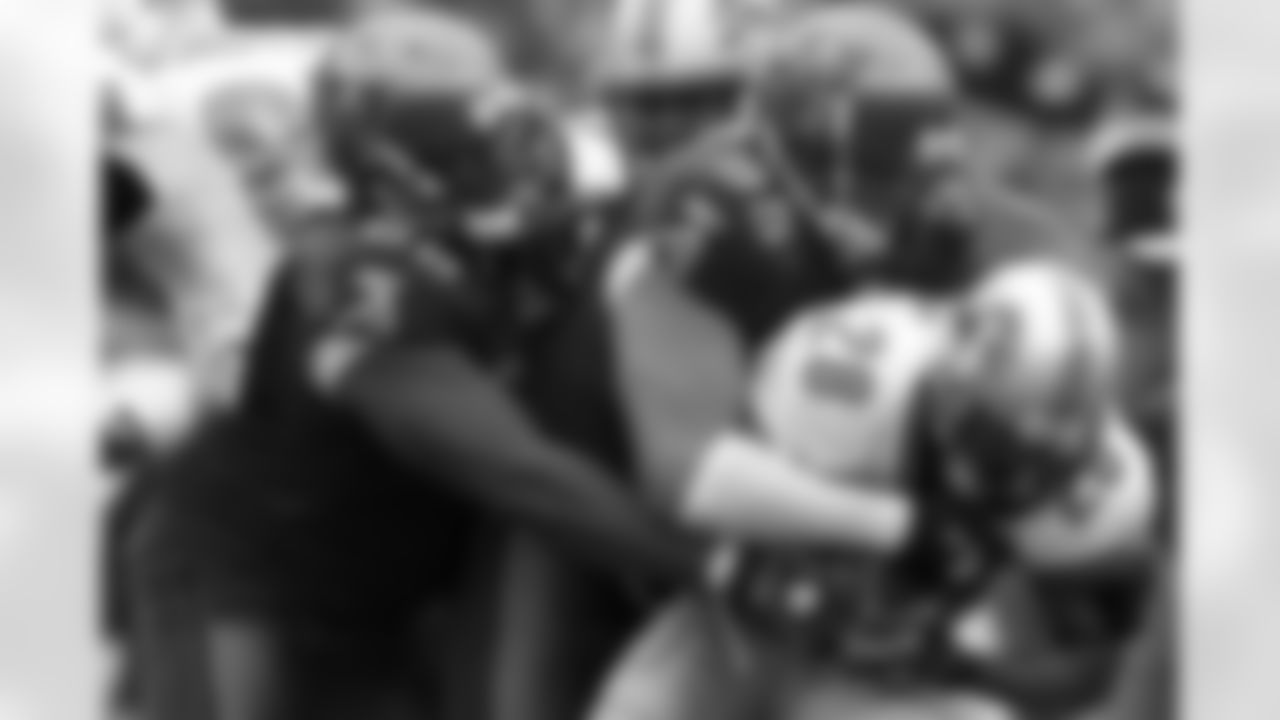 95 DT Al Woods reels in the ball carrier