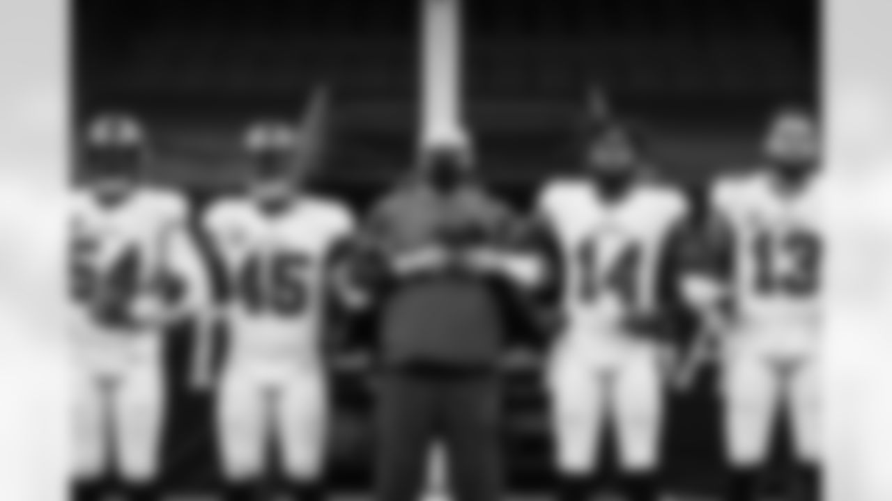 Buccaneers players and coaches stand in unity prior to Bucs vs. Saints, Week One