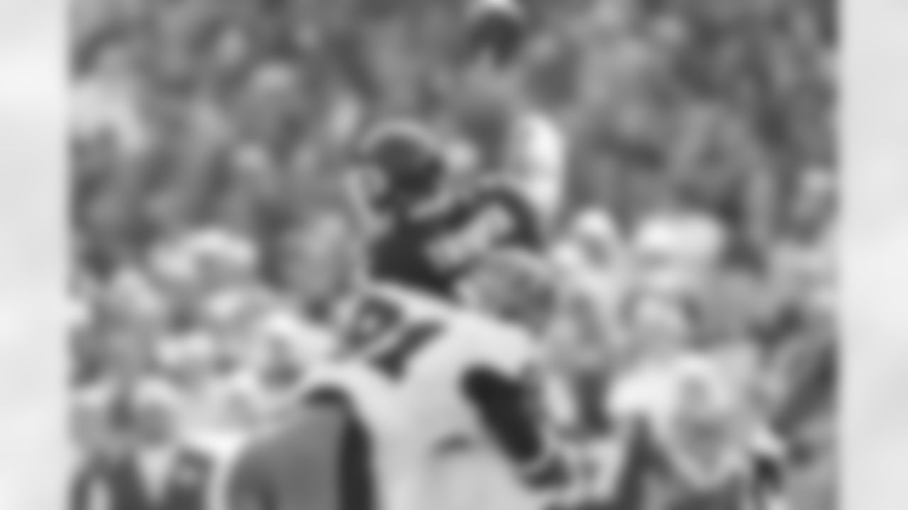 91 DE Greg White gets a hit as the QB releases the ball