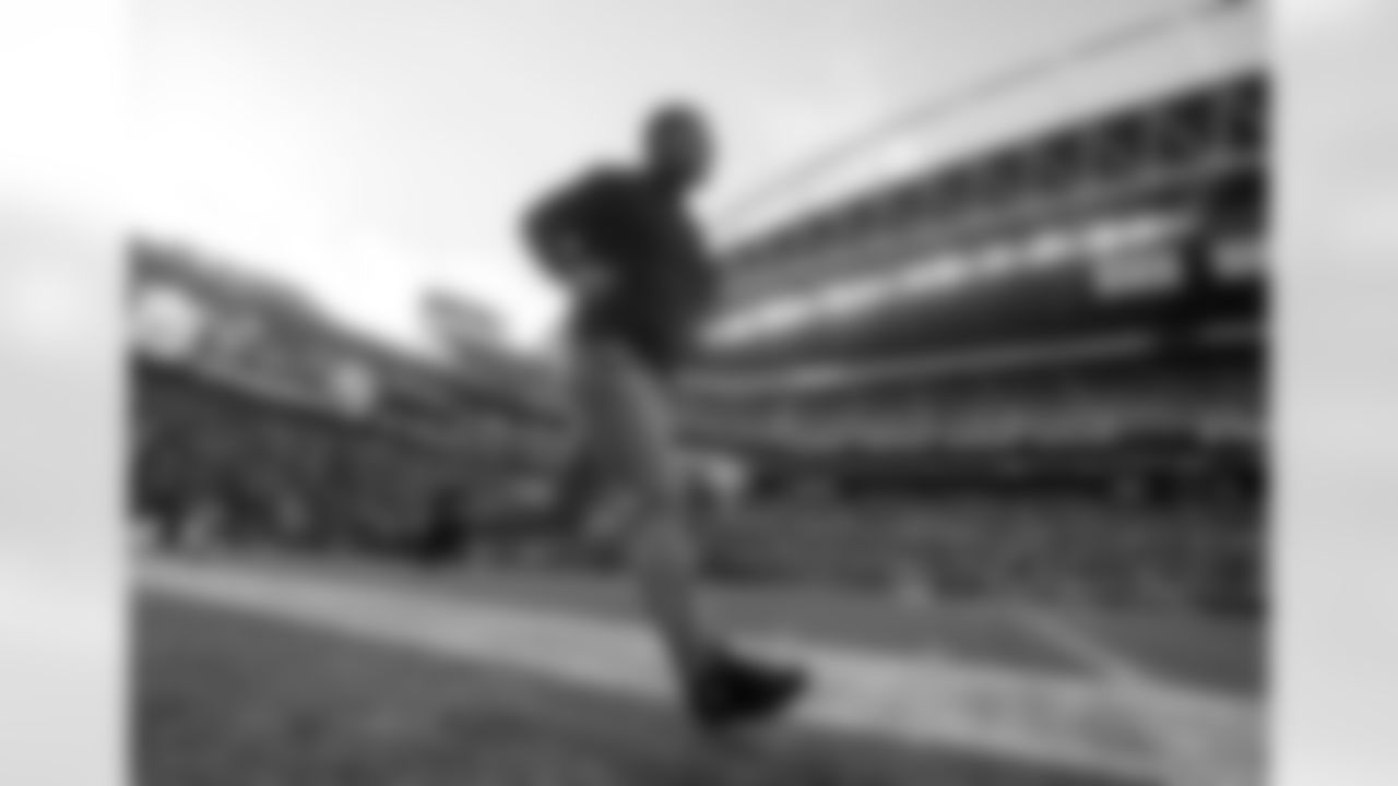 HC Greg Schiano runs on the field