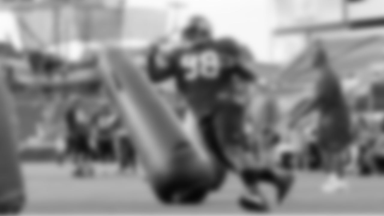 Defensive Tackle #98 Ryan Sims powers through the bags will running a drill
