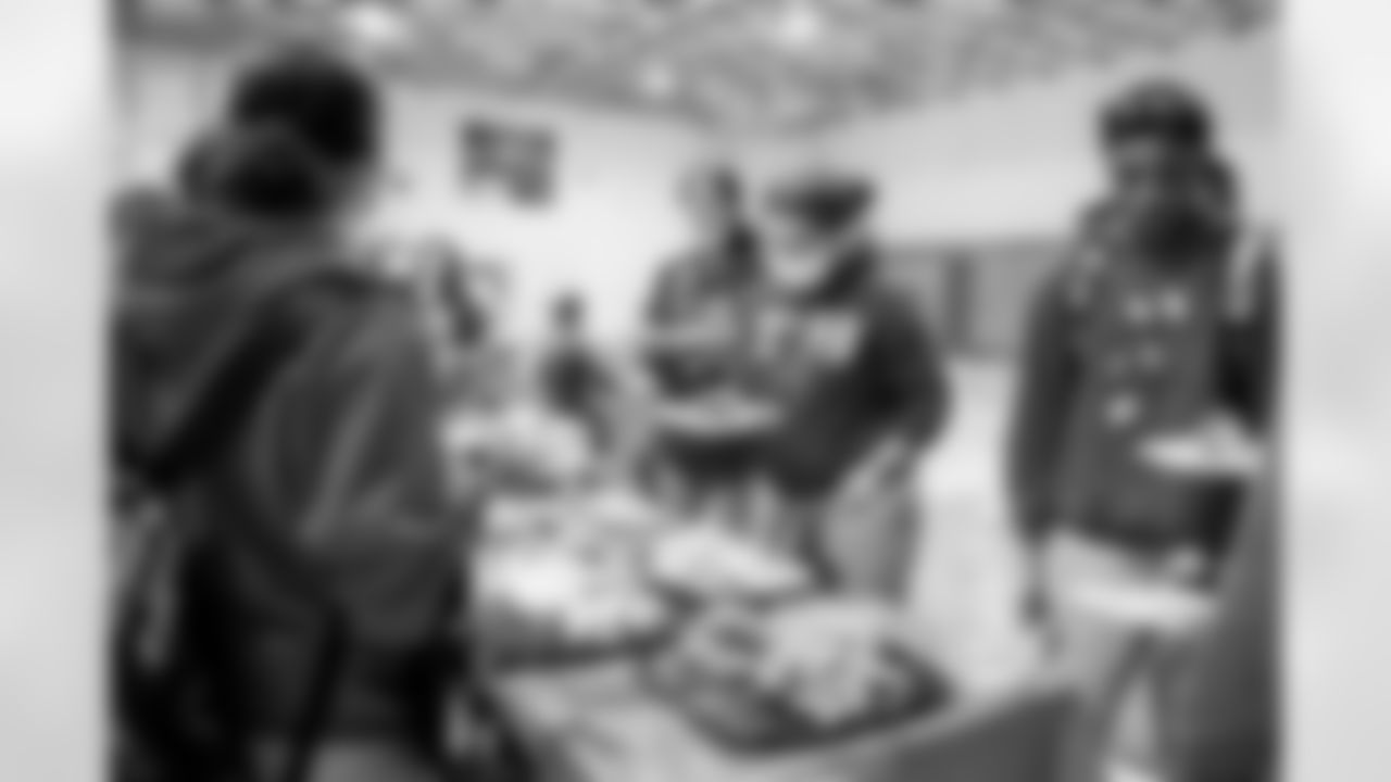 TAMPA, FL - December 15, 2022 - Students and staff share food, gifts, and games, during the 2022 Youth Leadership Program holiday party at Young Middle Magnet School. Photo By Kyle Zedaker/Tampa Bay Buccaneers