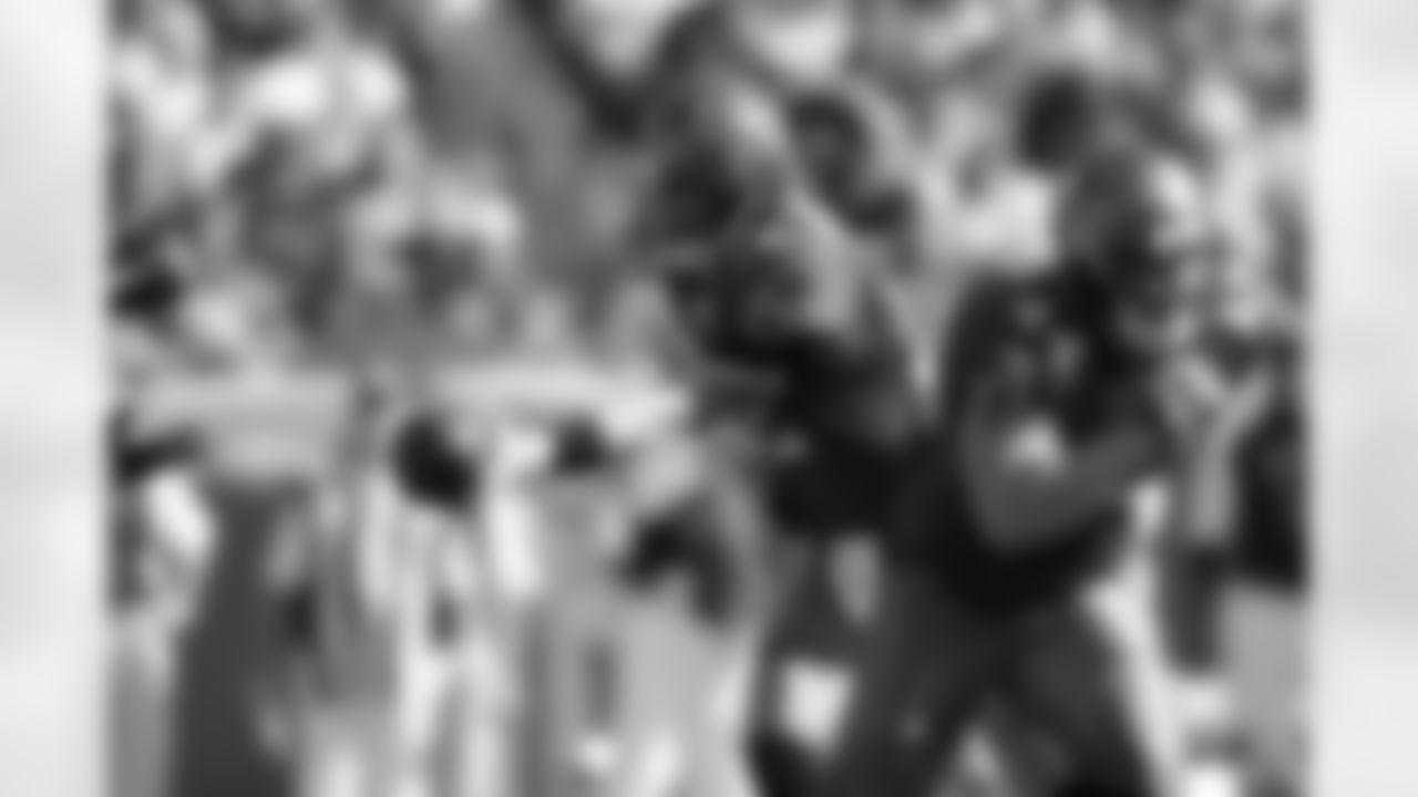 12 Luke McCown hands the ball off the Michael Bennett in the first half