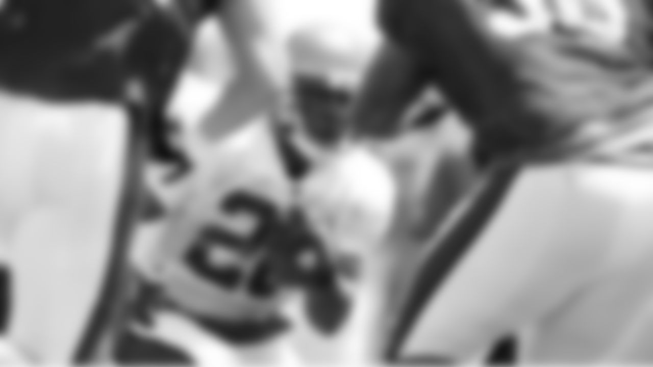RB Derrick Ward looks for a gap between several approaching defenders
