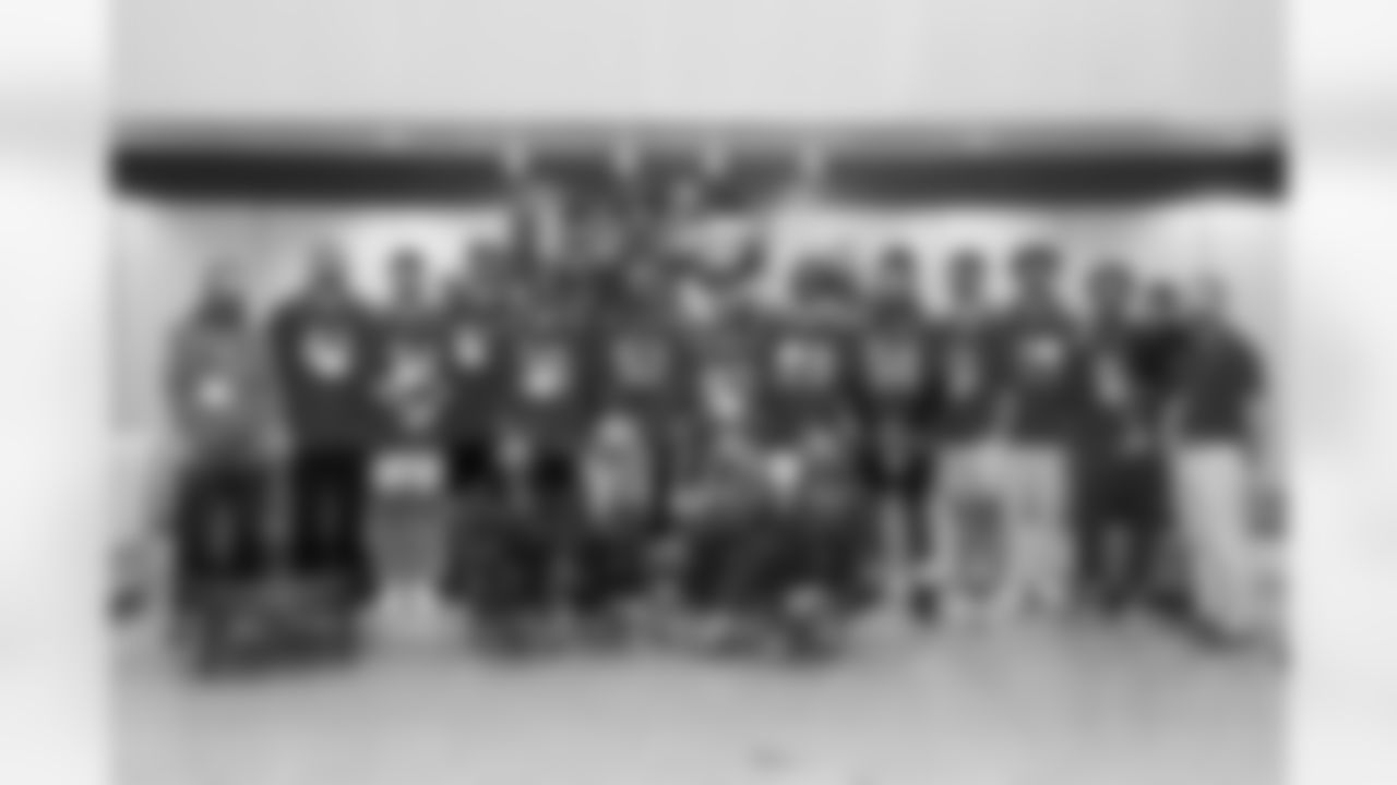 ST. PETERSBURG FL - December 13, 2022 - Tight End Ko Kieft #41, Safety Nolan Turner #34, Guard Luke Goedeke #67, Defensive Lineman Mike Greene #91, Tight End Cade Otton #88, Defensive Lineman Logan Hall #90, Cornerback Don Gardner #36, Inside Linebacker Olakunle Fatukasi #53, Wide Receiver Deven Thompkins #83, Running Back Rachaad White #29, Inside Linebacker J.J. Russell #51, Punter Jake Camarda #5, Cornerback Zyon McCollum #27, Wide Receiver Kaylon Geiger Sr. #80 of the Tampa Bay Buccaneers and Tampa Bay Buccaneers Cheerleaders and Captain Fear during the Rookie Club visit to Johns Hopkins All Children's Hospital. Photo By Tori Richman/Tampa Bay Buccaneers