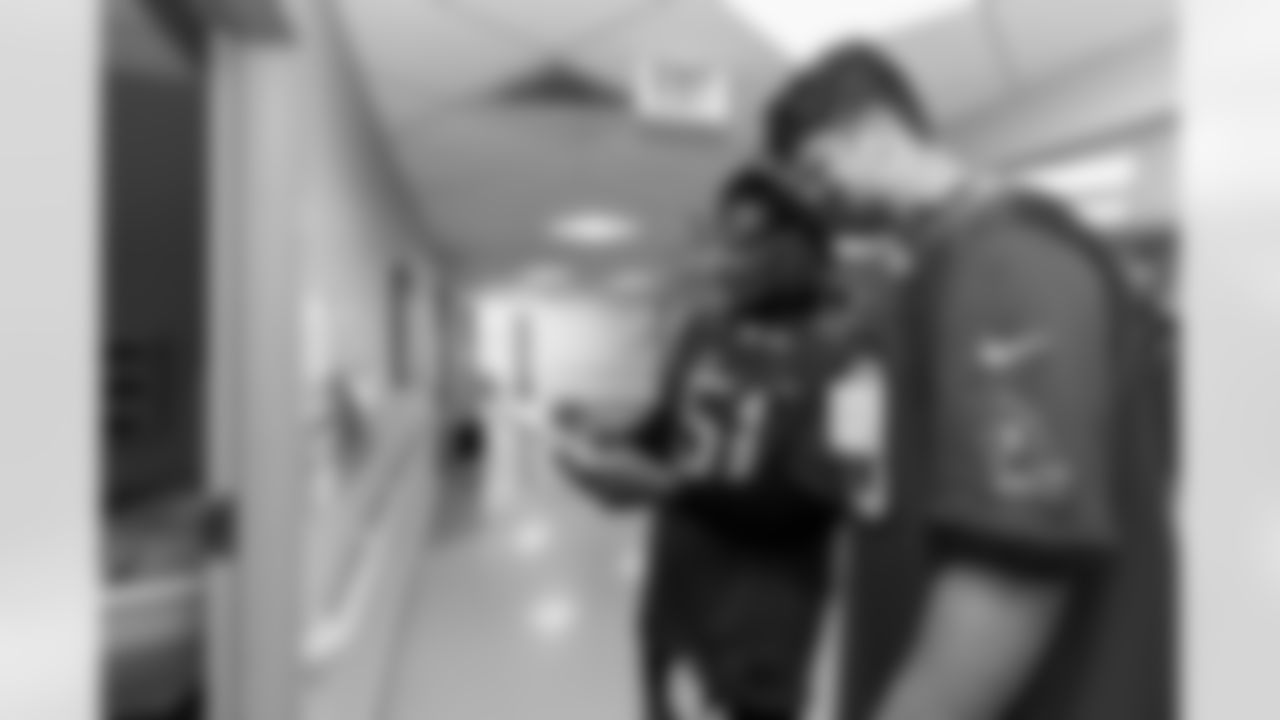 ST. PETERSBURG FL - December 13, 2022 - Inside Linebacker J.J. Russell #51 and Tight End Cade Otton #88 of the Tampa Bay Buccaneers during the Rookie Club visit to Johns Hopkins All Children's Hospital. Photo By Tori Richman/Tampa Bay Buccaneers