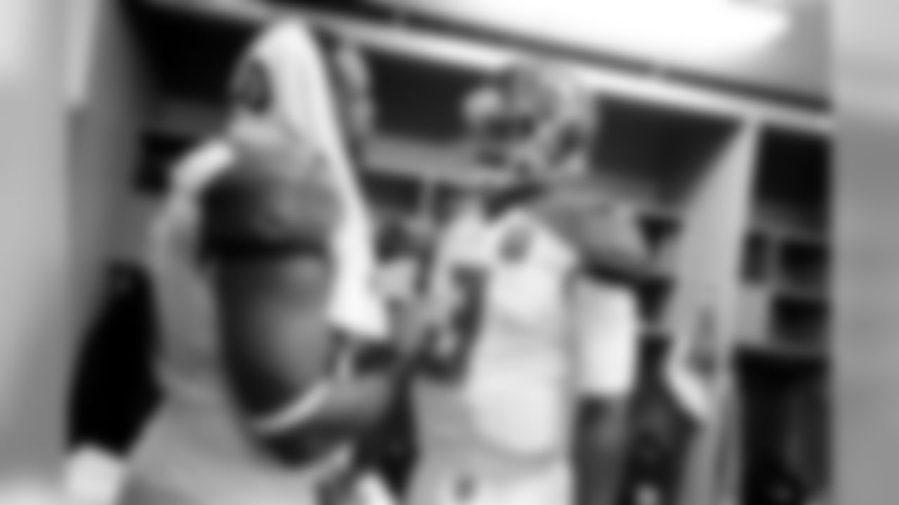 Jameis Winston talking with Gerald McCoy in the locker room.