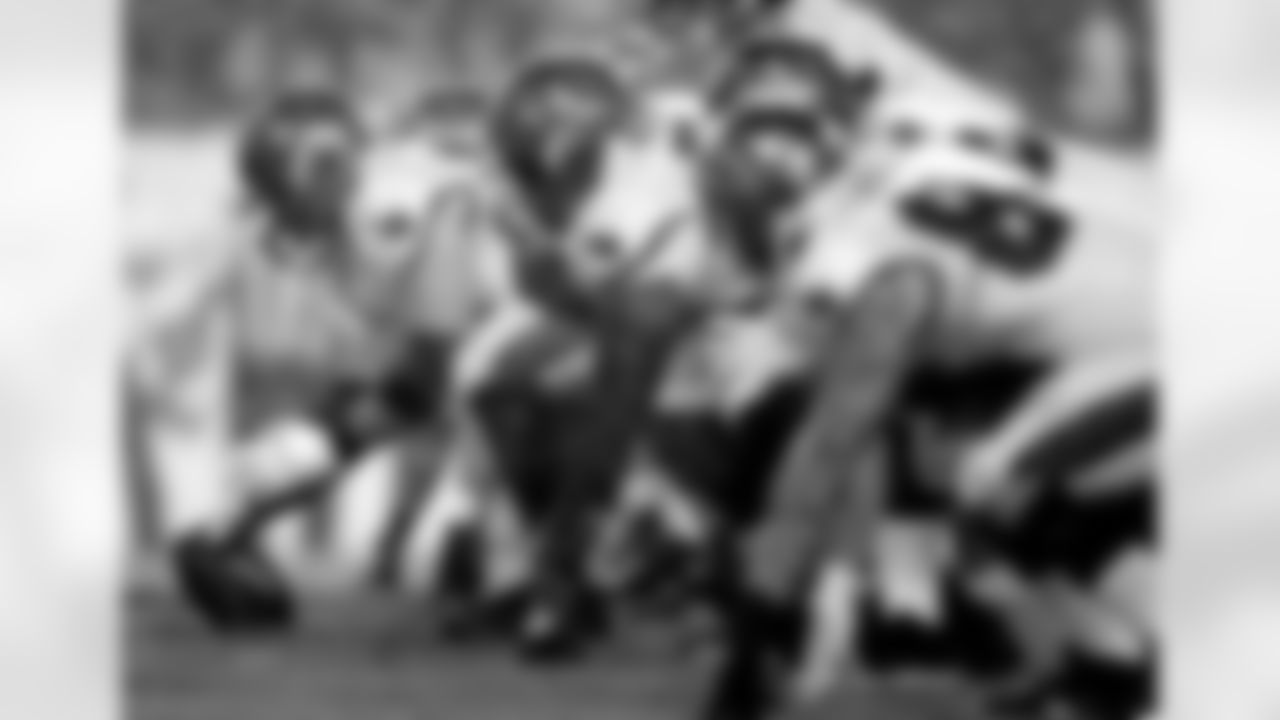 The Buccaneer offense lines up for a snap during a rain-soaked second quarter of preseason football.