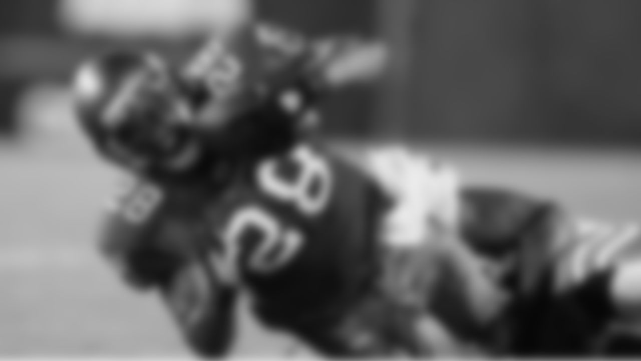 28 RB Derrick Ward lunges ahead for extra yardage with a Dolphins defender wrapped around his legs