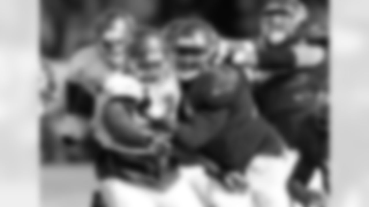 97 DT Akeem Spence and #77 OL Caleb Benenoch