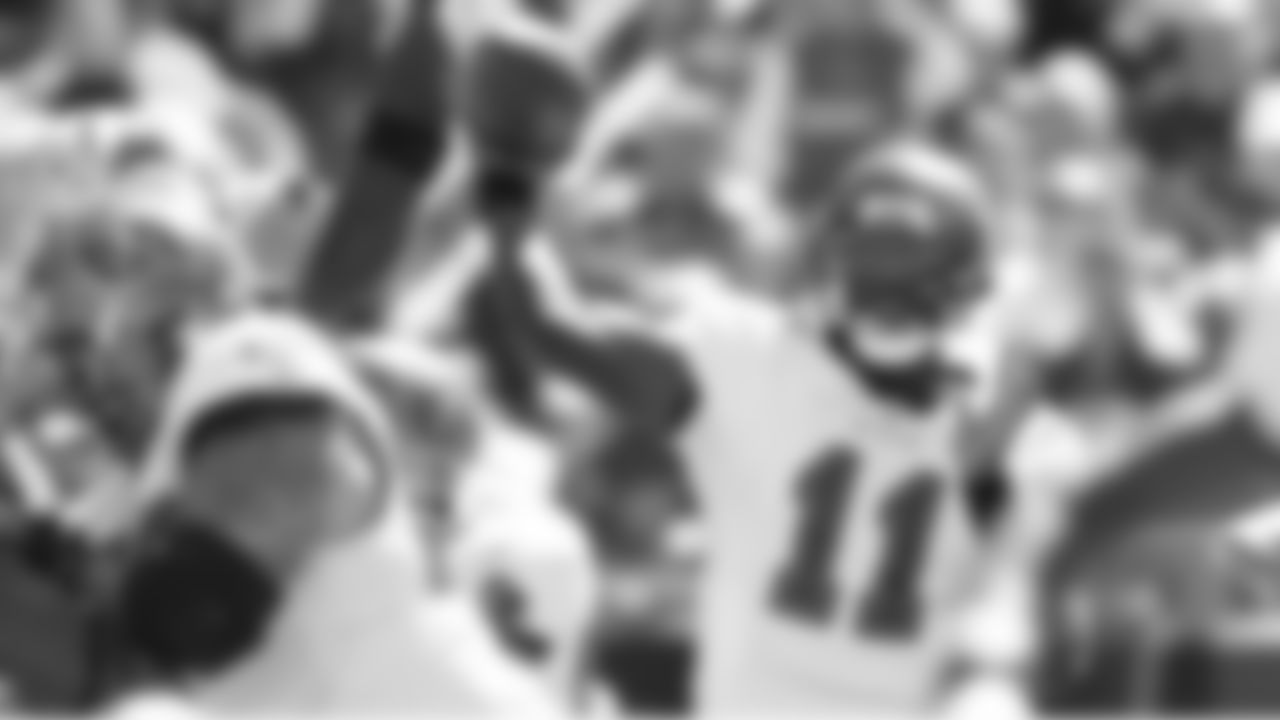 11 QB Josh Johnson looks for a receiver through tight opposition