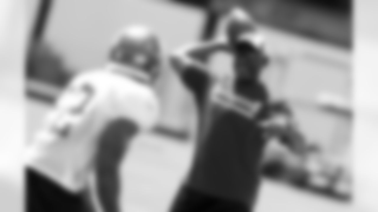 Running Backs Coach Earnest Byner works with the team during passing drills.