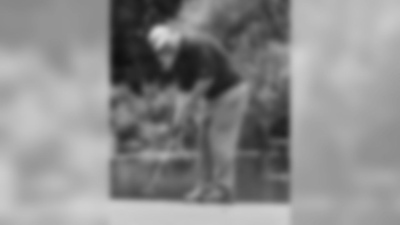 Defensive Line Coach Larry Coyer wills his putt to the cup