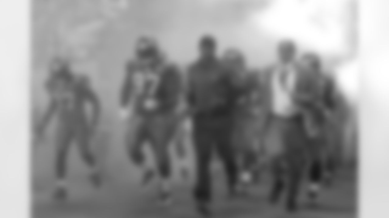 Head Coach Raheem Morris of the Tampa Bay Buccaneers leads his team out of the tunnel with Defensive End Jimmy Wilkerson #97 and Henry Duran against the New England Patriots at Wembley Stadium in London, England on October 25, 2009.