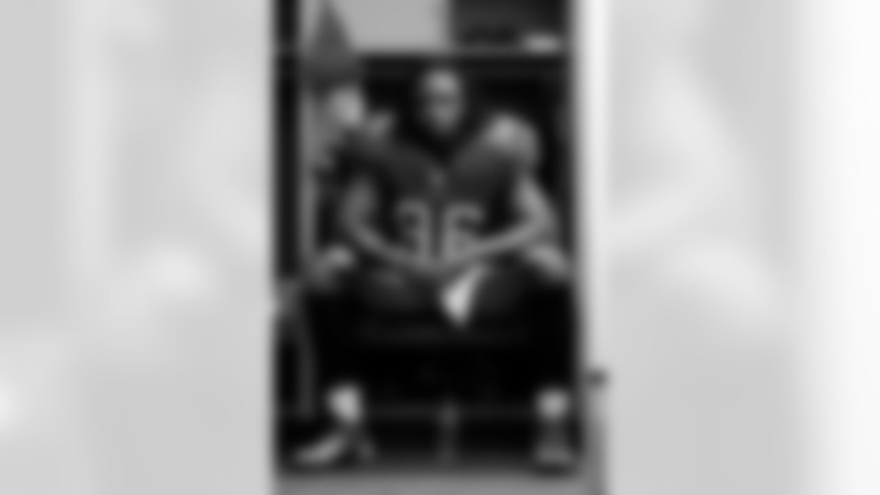 DE Steven Means sits in his locker before the game.