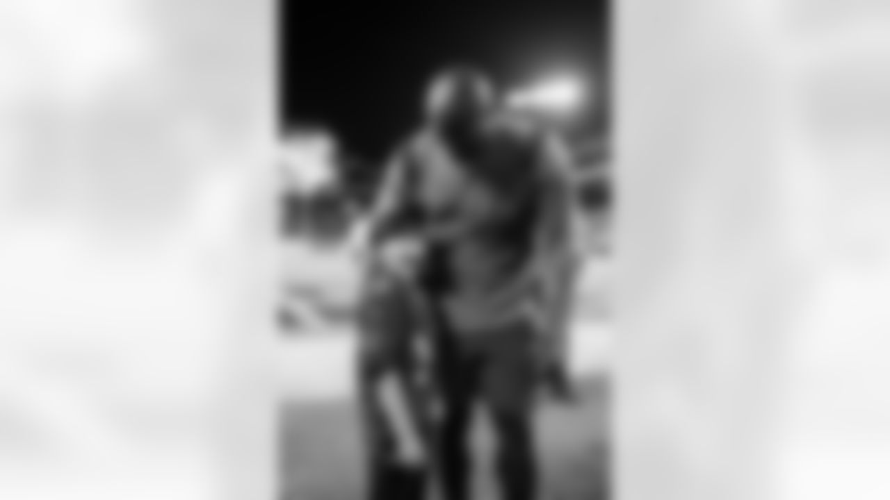 TAMPA, FL - December 05, 2022 - Running Back Leonard Fournette #7 of the Tampa Bay Buccaneers takes a photo with a fan before the game between the New Orleans Saints and Tampa Bay Buccaneers at Raymond James Stadium. The Buccaneers won the game, 17-16. Photo By Kyle Zedaker/Tampa Bay Buccaneers