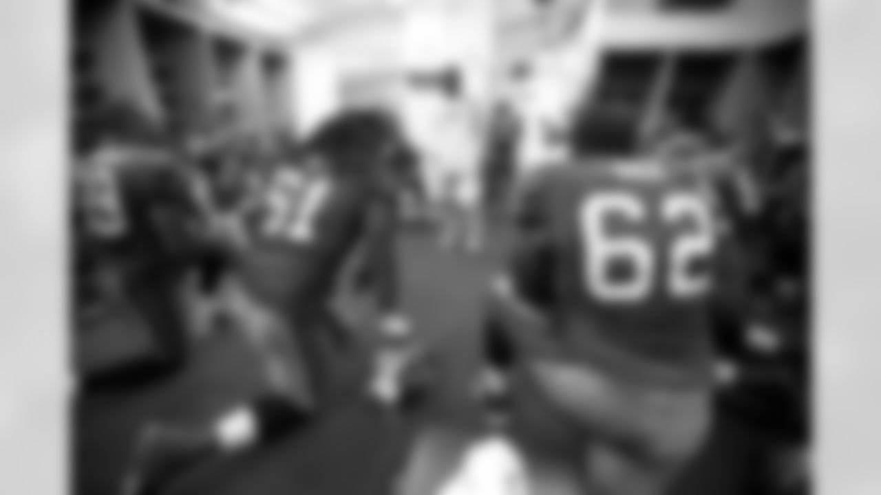 Head Coach Raheem Morris of the Tampa Bay Buccaneers addresses his team including Safety Sabby Piscitelli #21, Cornerback Marshall McDuffie #39, Defensive End Jarriett Buie #61, Tackle Marc Dile #62 in the locker room against the Miami Dolphins at Raymond James Stadium in Tampa, Florida on August 27, 2009.