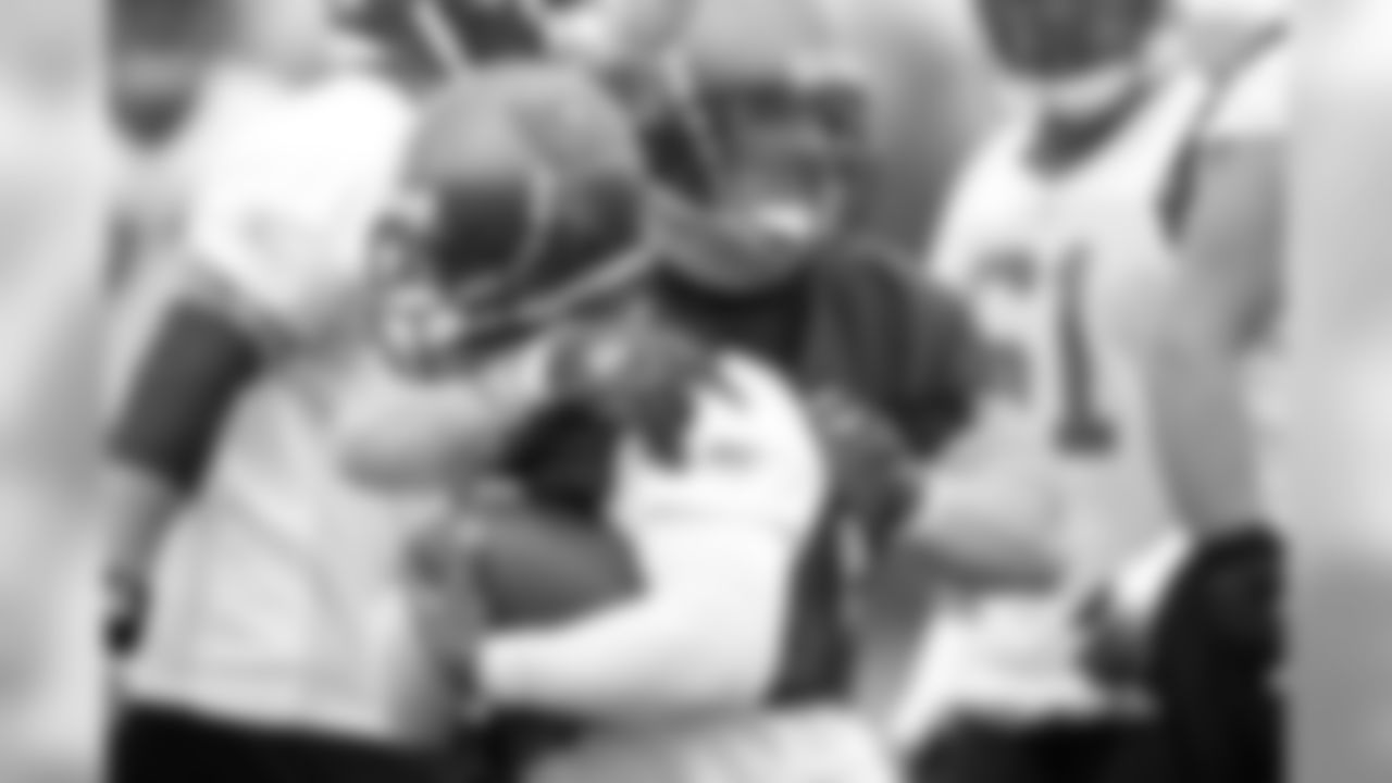 DT Chris Hovan ends up with his arm around the neck of RB Kenneth Darby