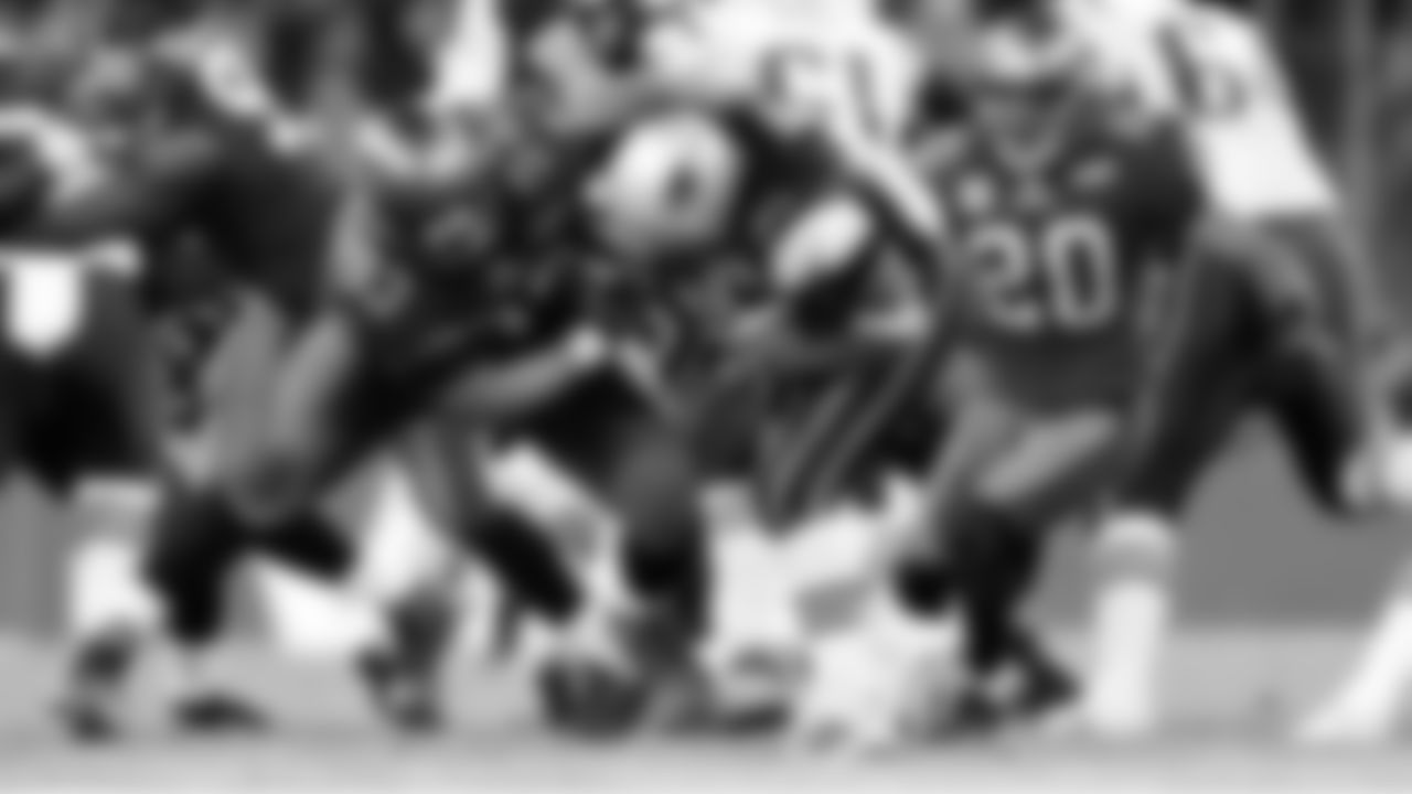 93 DT Roy Miller wrangles in the runner