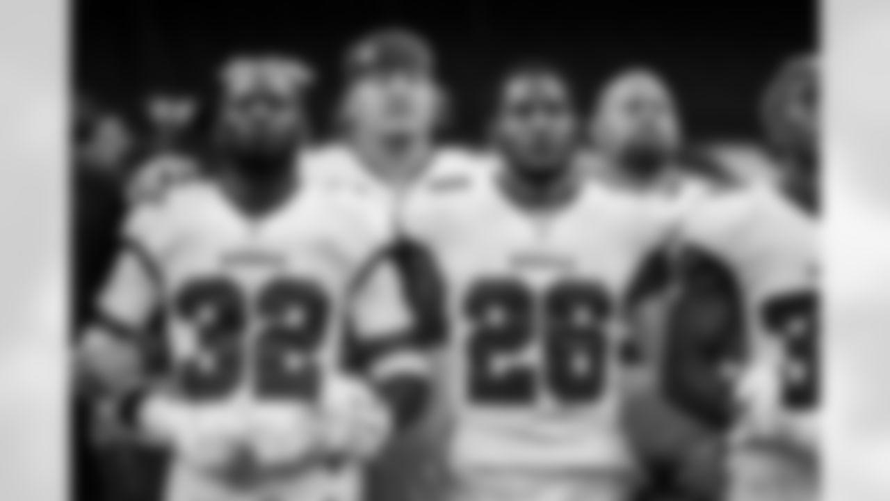 Buccaneers players and coaches stand in unity prior to Bucs vs. Saints, Week One