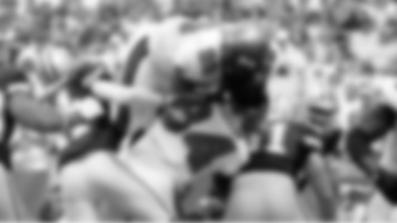 28 RB Derrick Ward leaps over the pile to score a touchdown