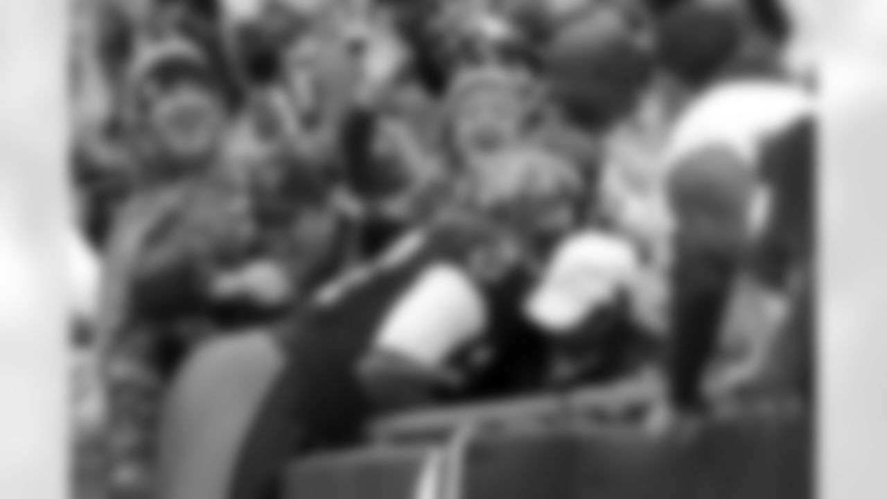 27 RB Legarrette Blount leaps into the stands to get some love from the crowd