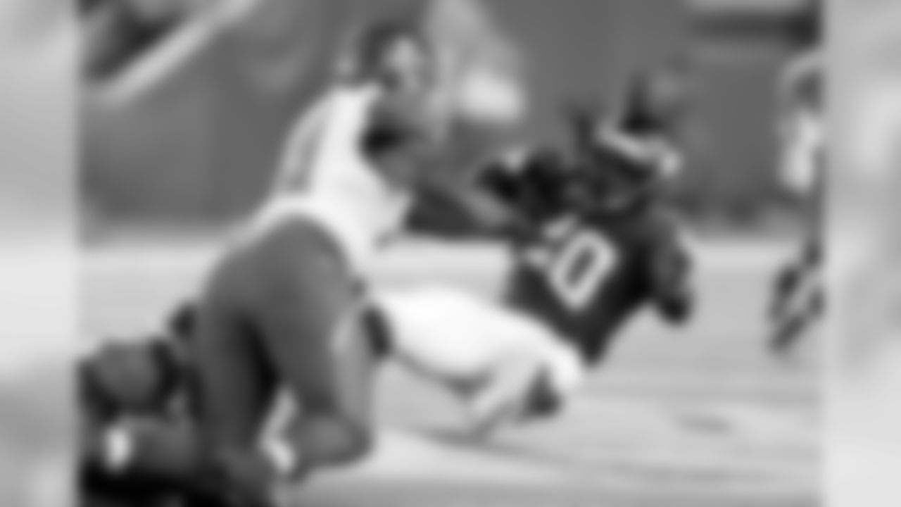 DT Caushaud Lyons (68) pops RB DuJuan Harris in the middle of the field.