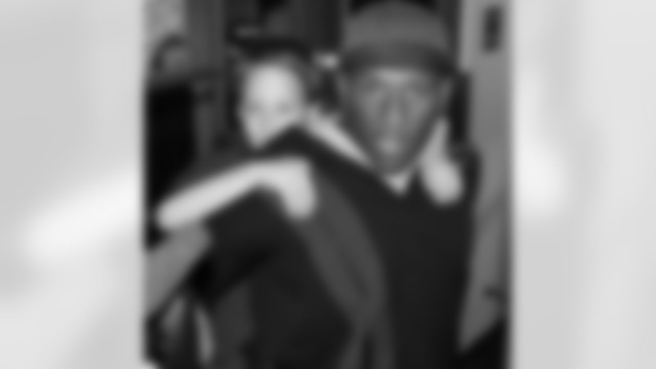 Clark Haggans gives a lift to a young fan in search of Beanie Wells