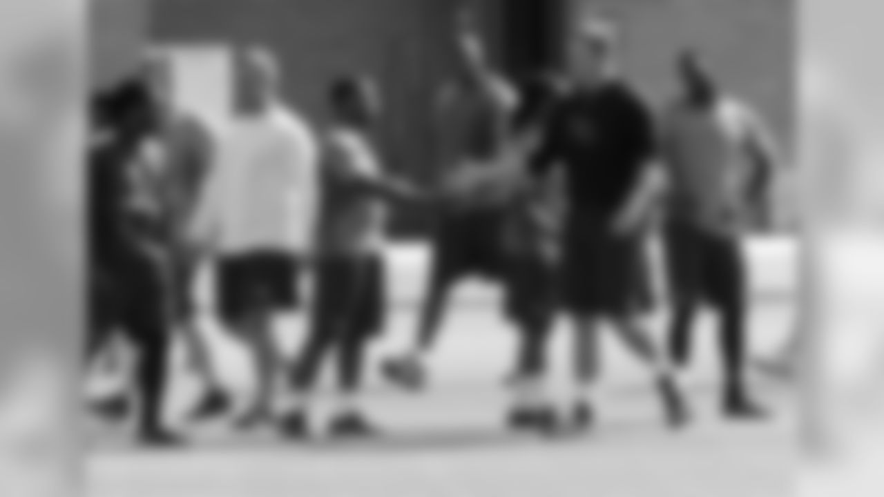 As the big guys leave the bubble after their workout, T Bradley Sowell greets RB Stepfan Taylor and his teammates who are still in the middle of sprints