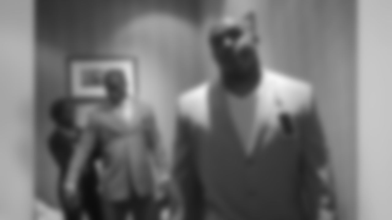 DT Dan Williams (right) tries on a suit in preparation for the 2010 NFL draft.