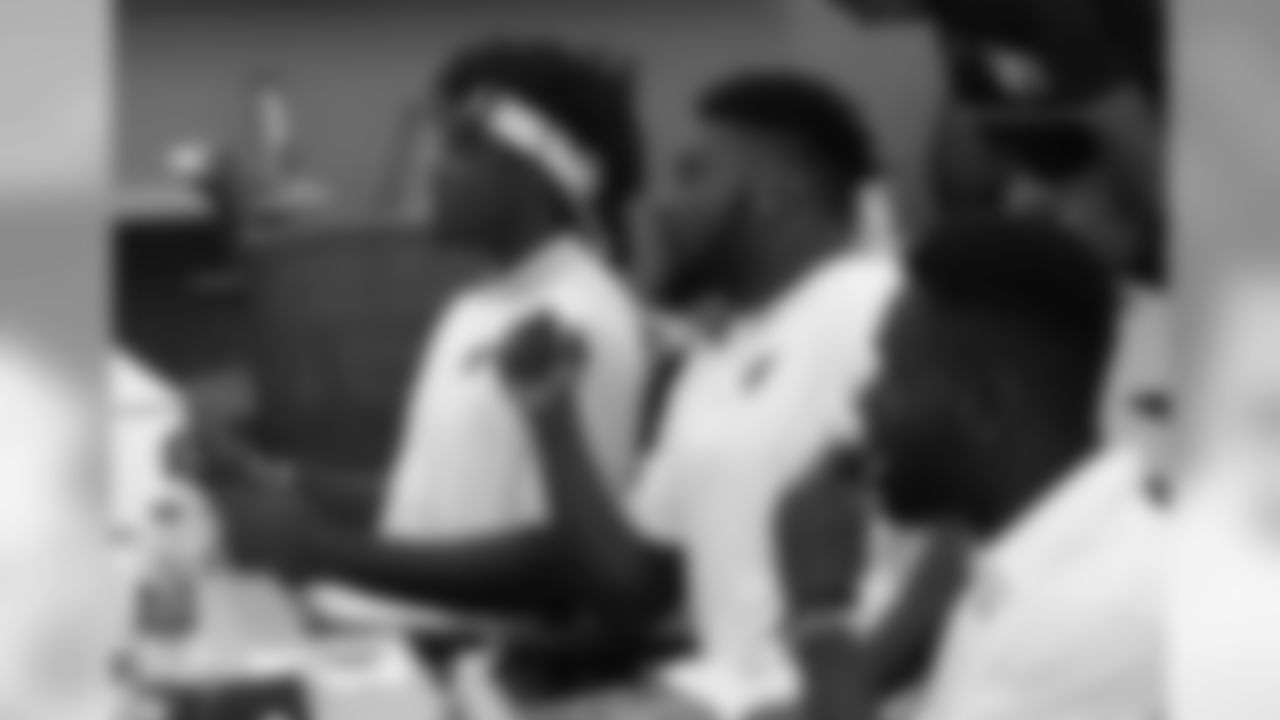 WR Chad Willams (left) and RB T.J. Logan listen to Sheriff Paul Penzone