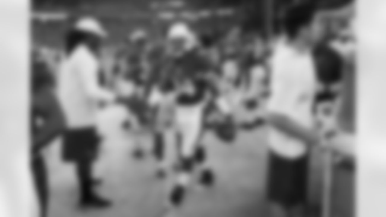 Williams holds the game ball after his first NFL touchdown