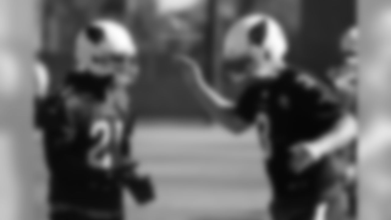 CB Patrick Peterson (left) and QB Carson Palmer slap five