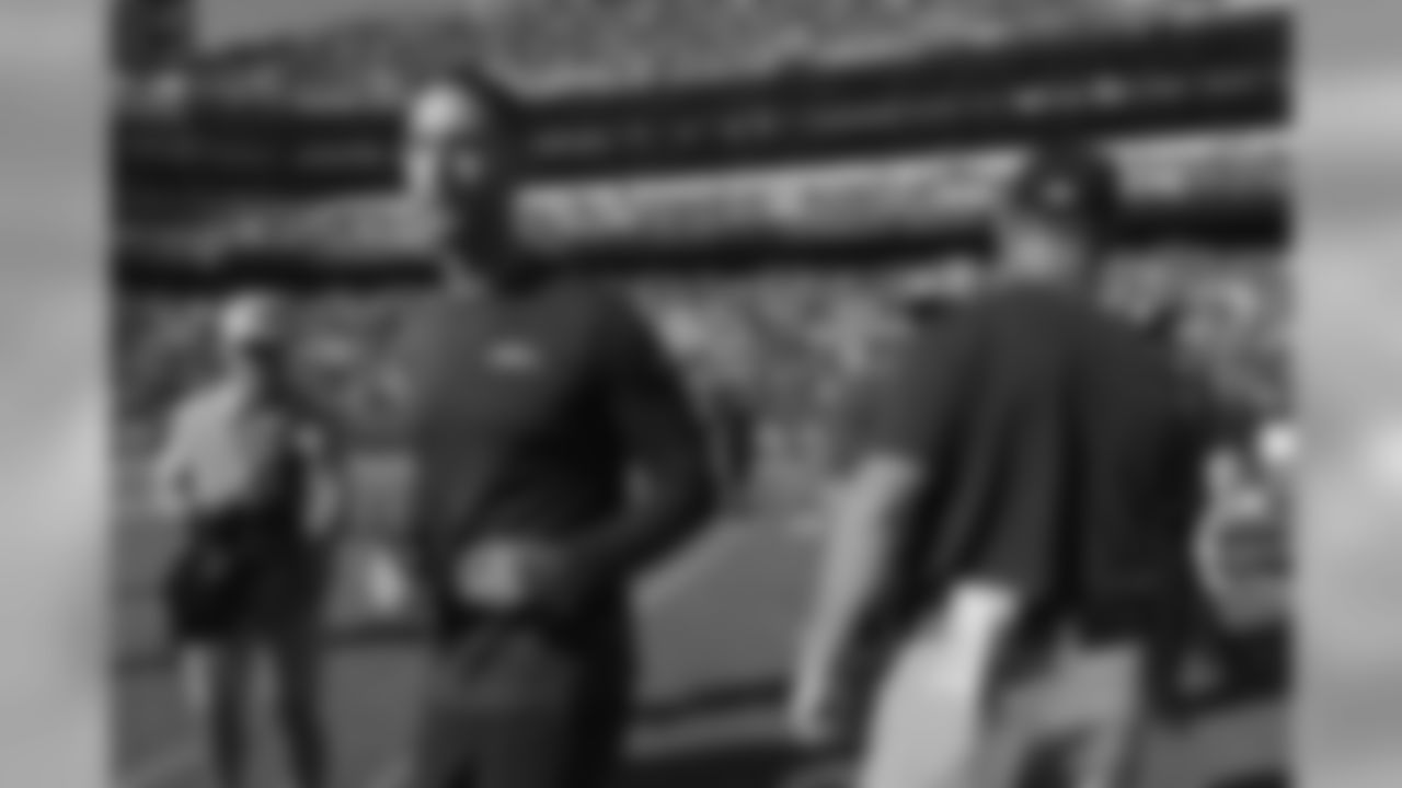 Cardinals head coach Kliff Kingsbury, left, walks off the field after speaking with Baltimore Ravens head coach John Harbaugh, right, after the game. Baltimore won 23-17.