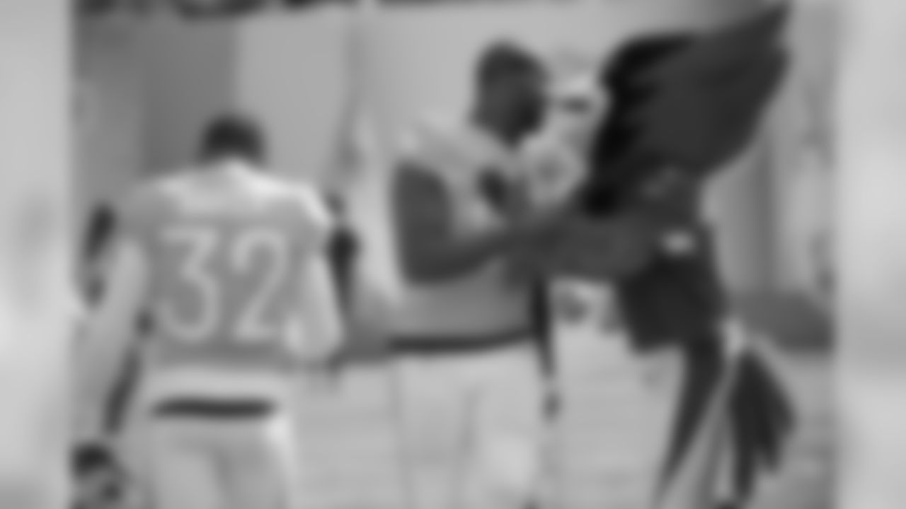 Cardinals outside linebacker Chandler Jones (55) and free safety Budda Baker (32) are met by the team's mascot during player introductions before the NFL Pro Bowl football game against the AFC Sunday, Jan. 26, 2020 in Orlando, Fla.
