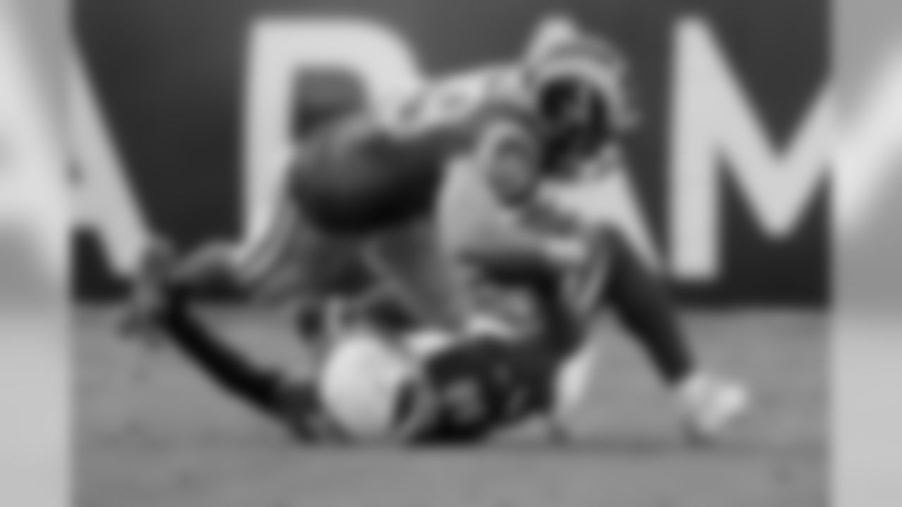 Rams tight end Tyler Higbee is tackled by Cardinals linebacker Jordan Hicks.