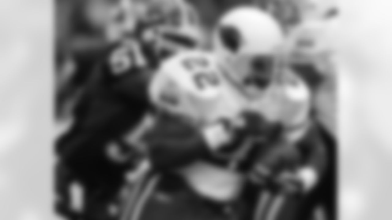 2004: RB Emmitt Smith runs the ball as Bills LB Takeo Spikes pursues