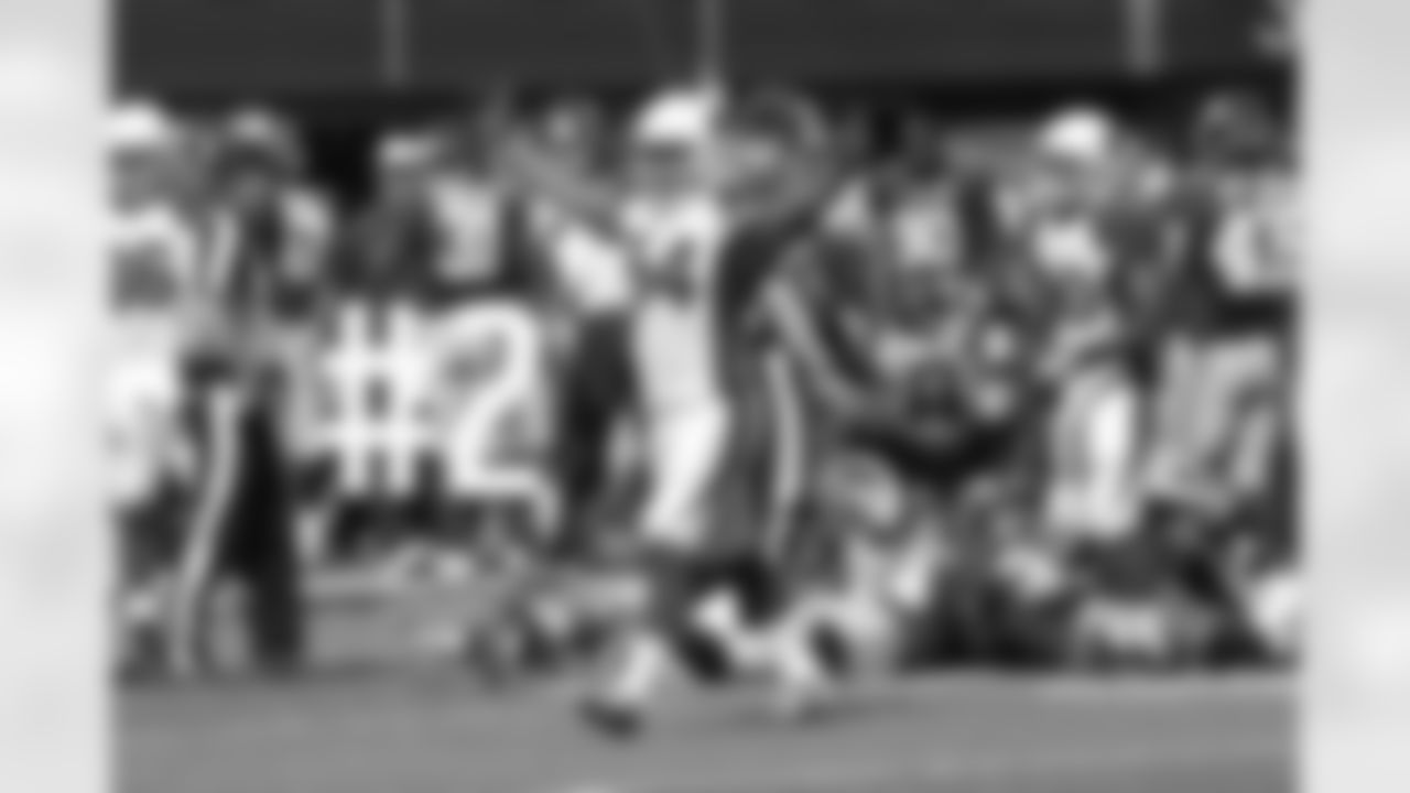 LB Kenny Demens celebrates a forced fumble as the players behind him scramble for the ball