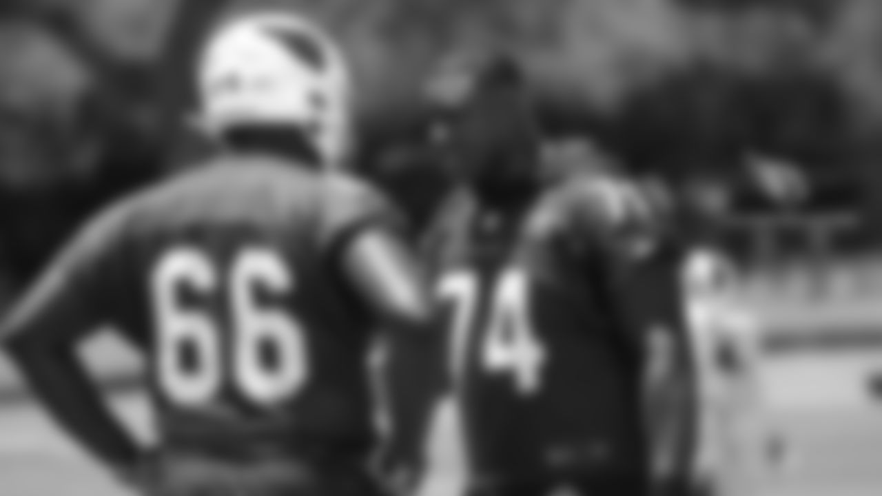 T D.J. Humphries (74) gives advice to rookie T Joshua Miles.